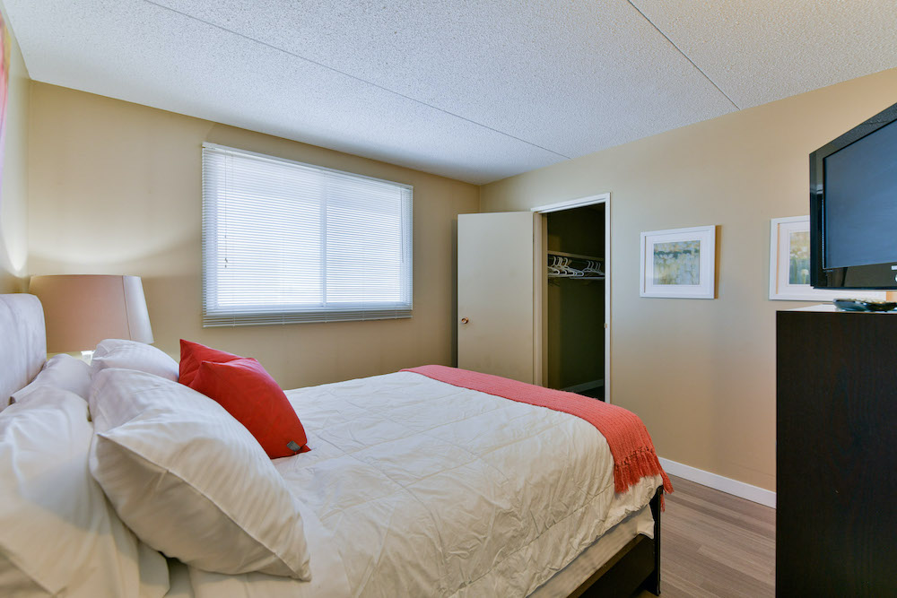 Master bedroom and closet of a unit at 243 Queen Street.