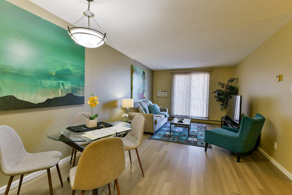Furnished living room and dining room of a unit at 243 Queen Street.